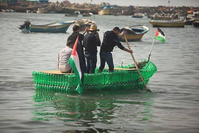 Palestinians make a boat out of empty plastic bottles
